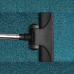 Janitorial Services in Alameda County, vacuum cleaning a blue rug