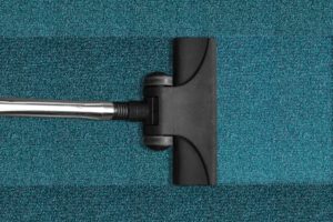 Janitorial Services in Alameda County, vacuum cleaning a blue rug