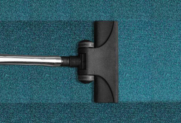 Janitorial Services in Alameda County, vacuum cleaning a blue rug