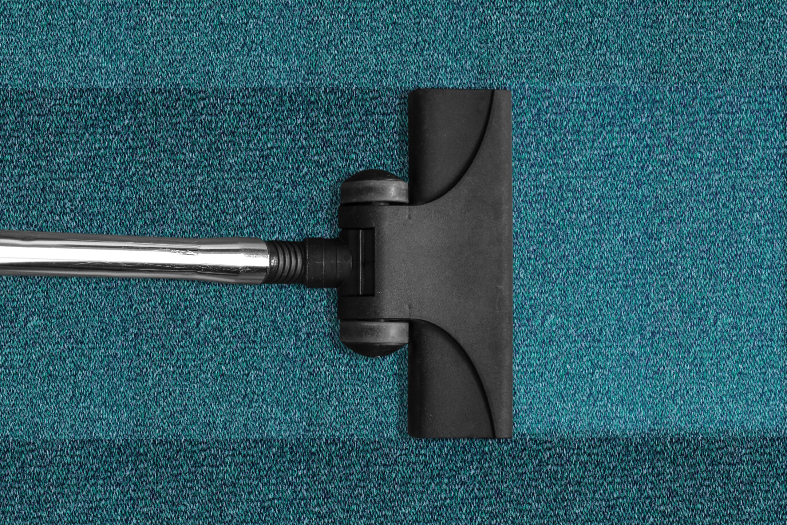 Janitorial Services in Alameda County, vacuum cleaning a blue rug