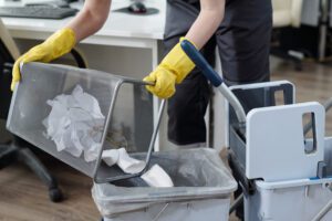 Office cleaning emptying waste bin
