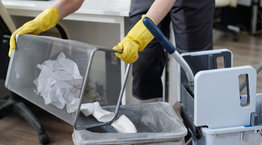 Office cleaning emptying waste bin